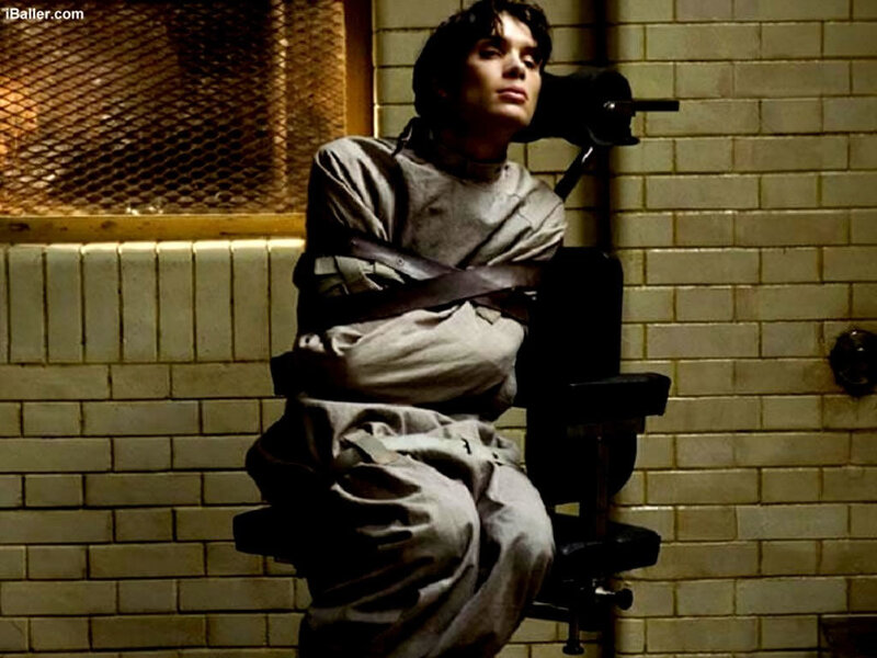 man restrained in chair