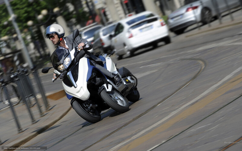 Man riding a motorcycle on a city street