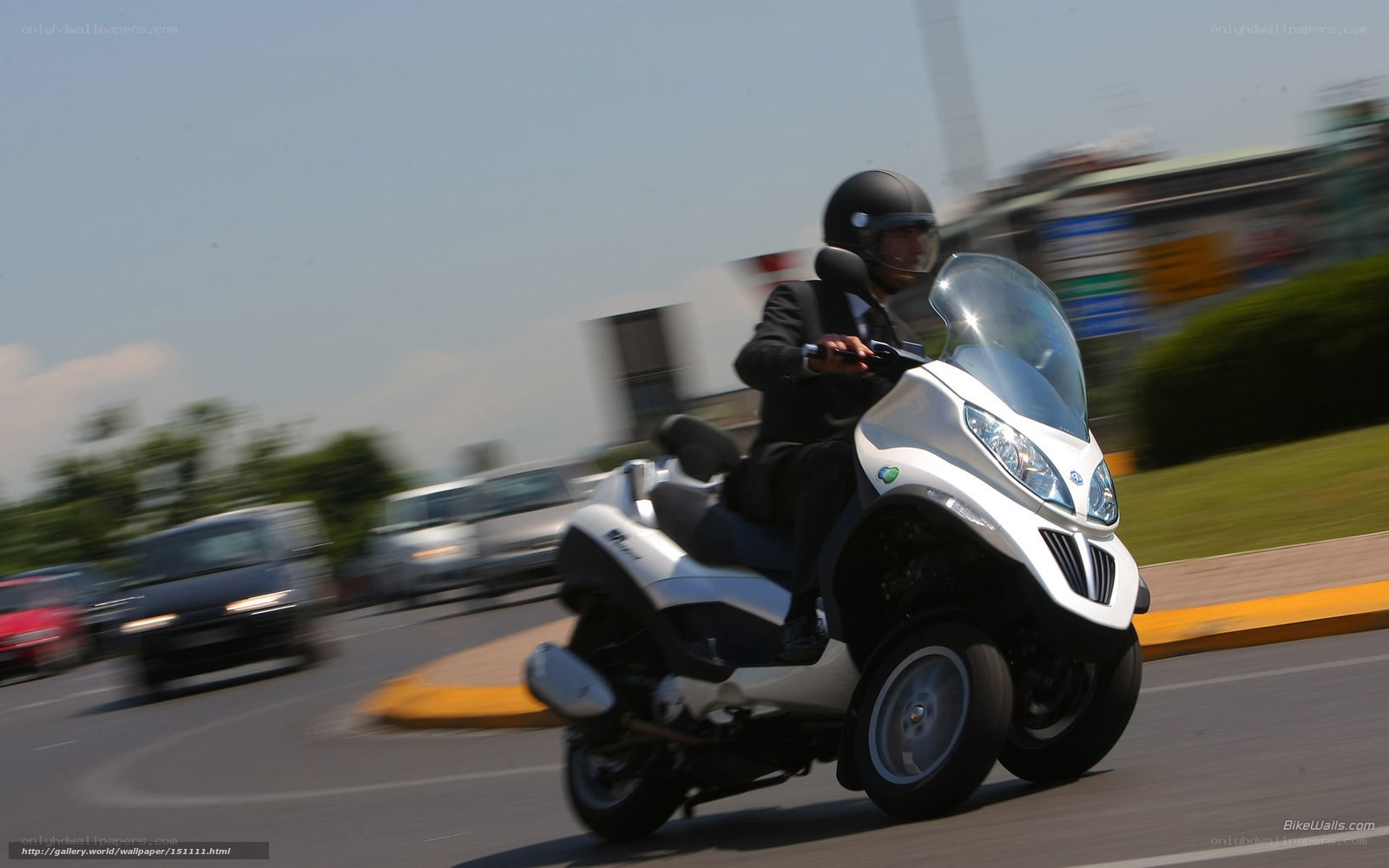 Man riding a scooter on a road