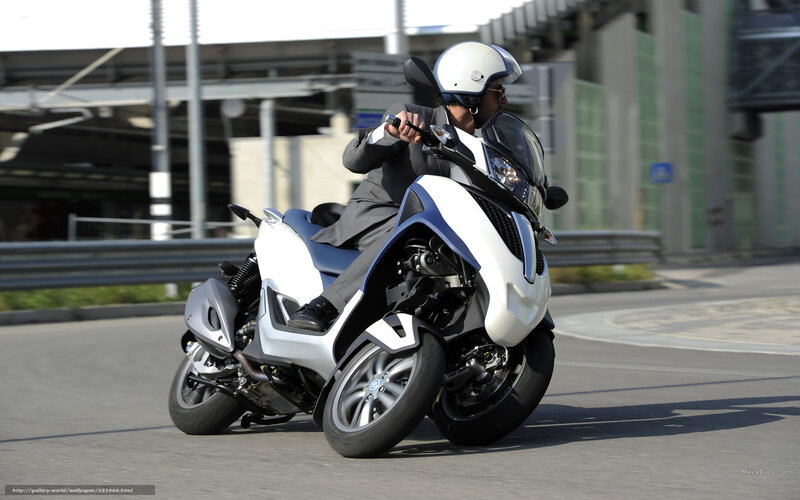 man riding a three-wheeled motorcycle