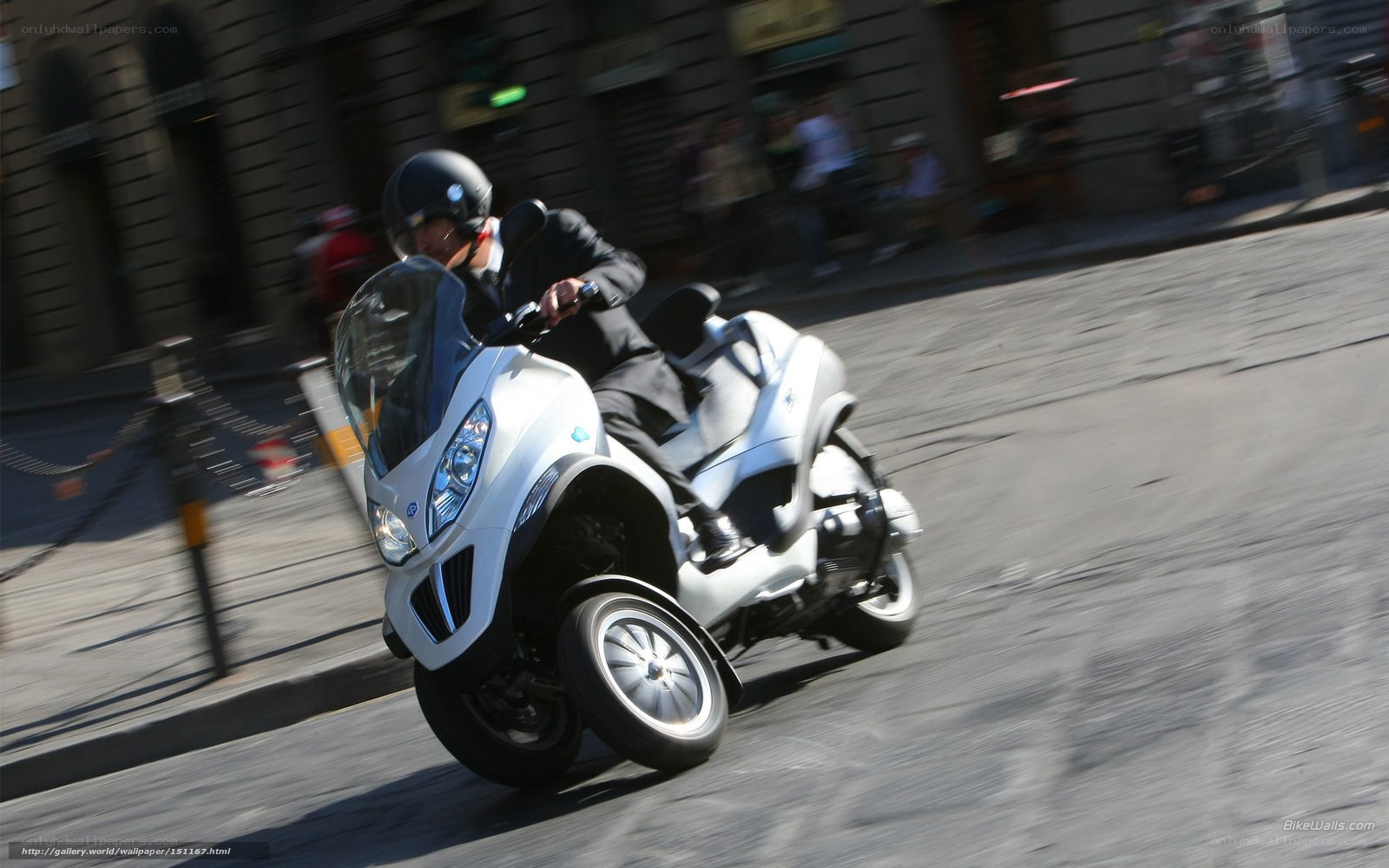 Man riding a three-wheeled scooter