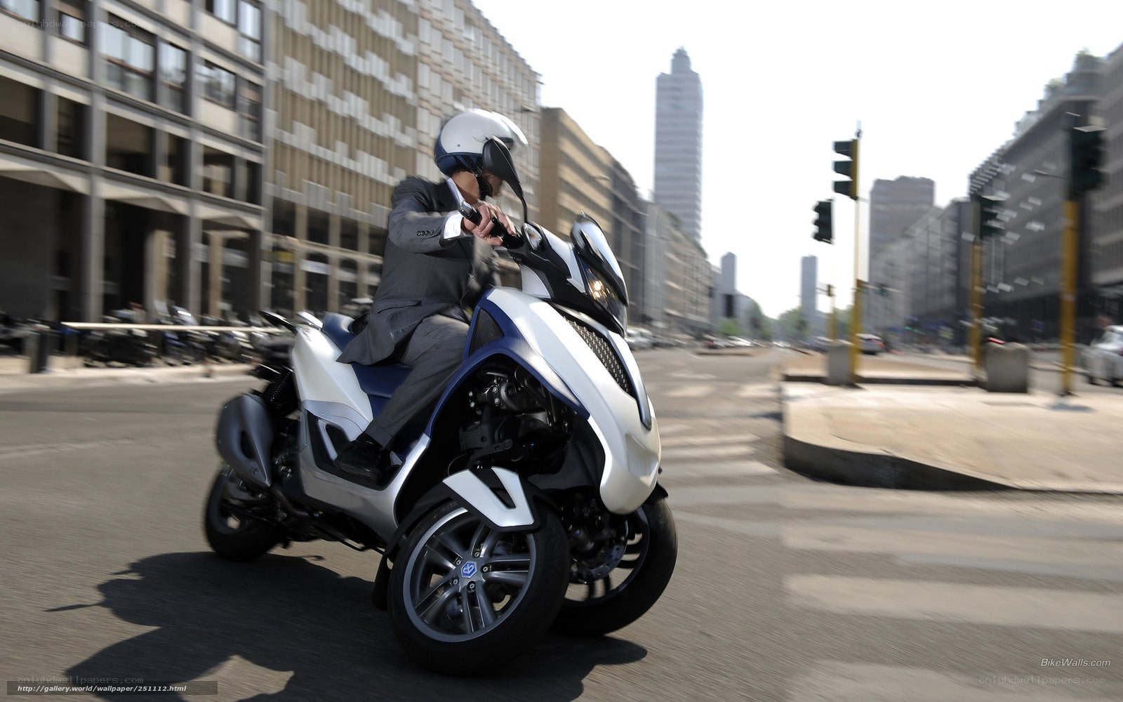 Man riding a three-wheeled scooter