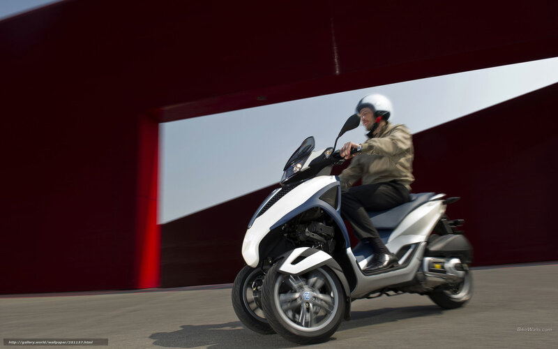 Man riding a three-wheeled scooter