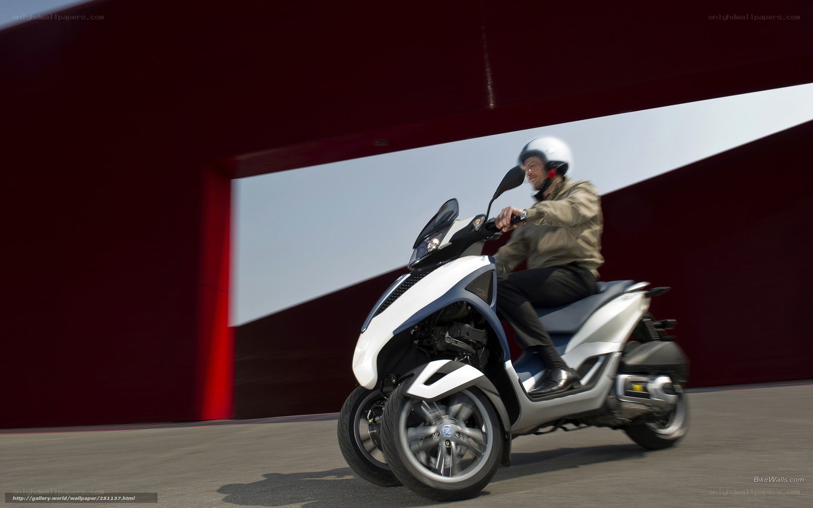 Man riding a three-wheeled scooter