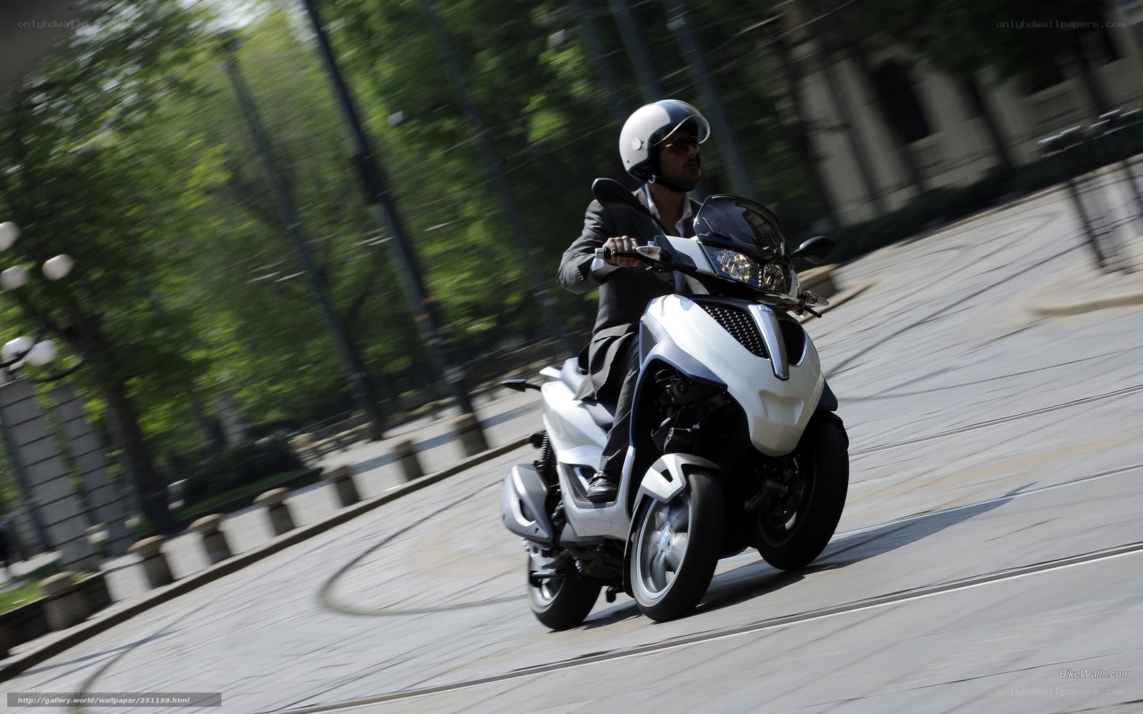 Man riding a white scooter
