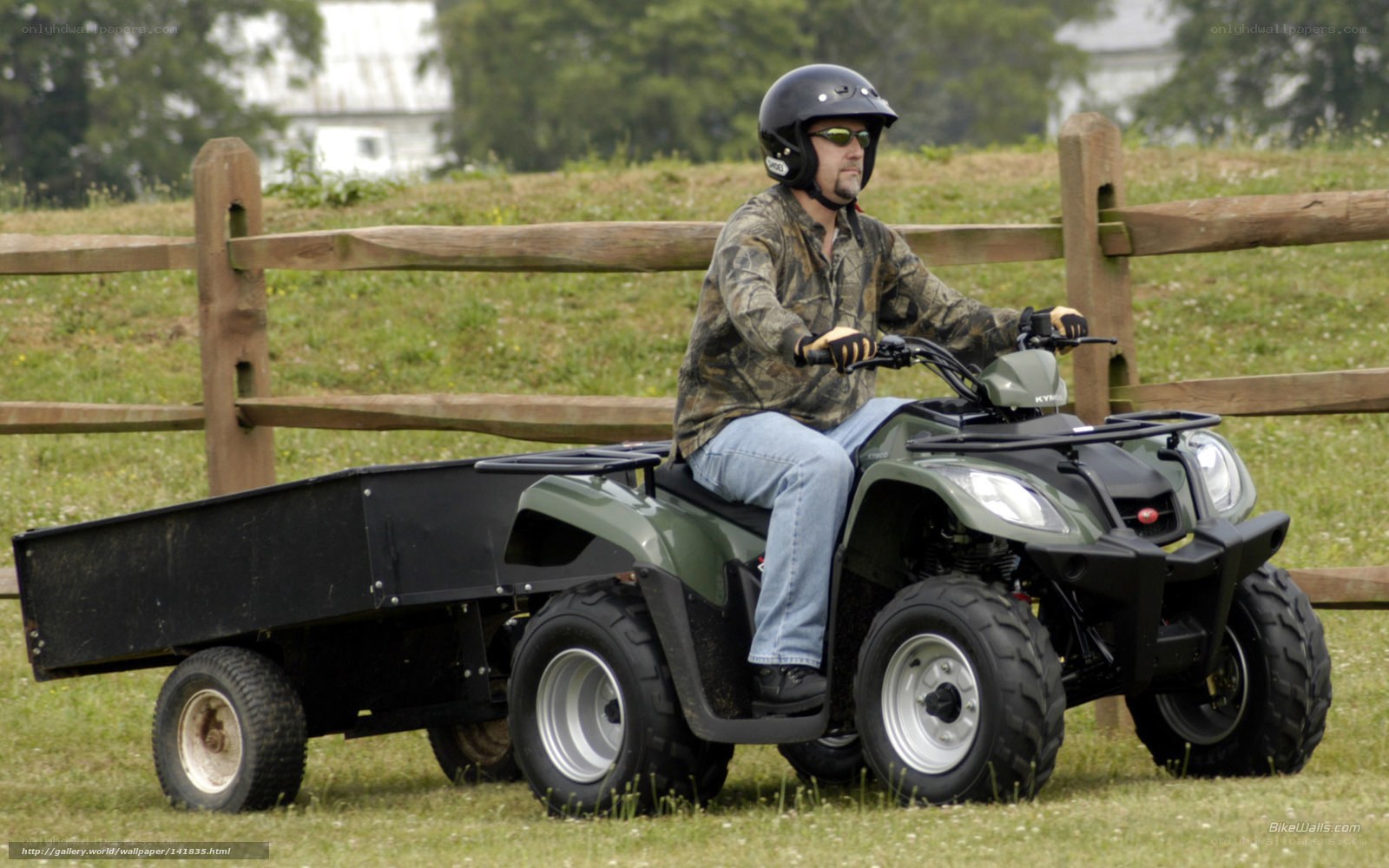 Man riding ATV with trailer