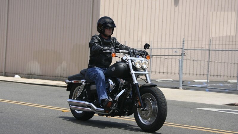 man riding black motorcycle