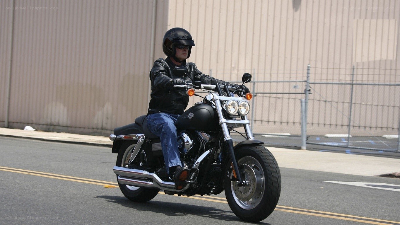 man riding black motorcycle