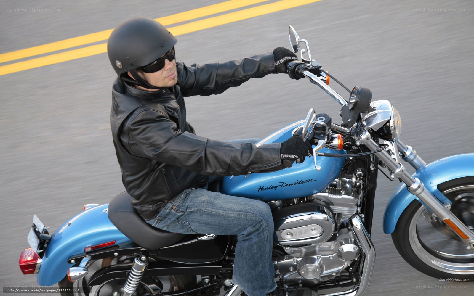 Man riding blue motorcycle