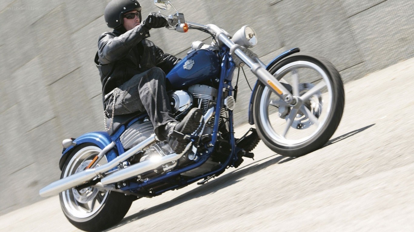Man riding blue motorcycle