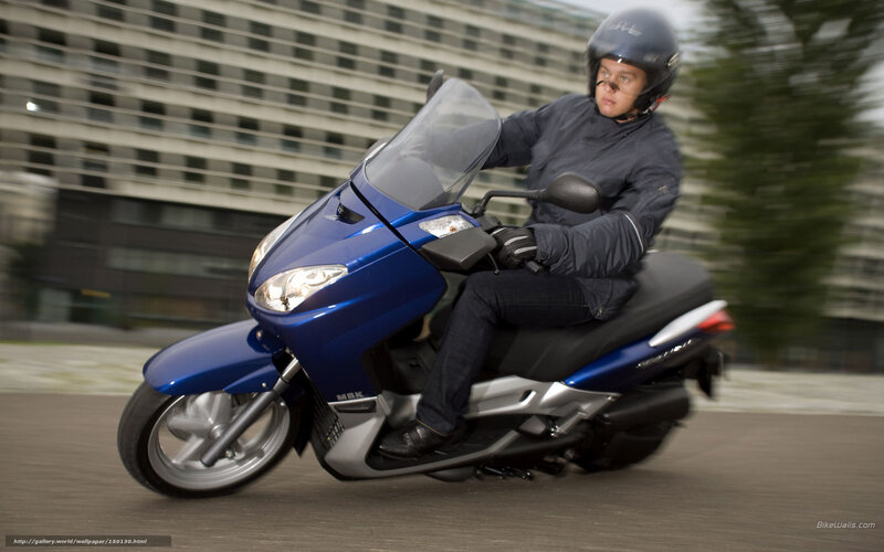 Man riding blue scooter