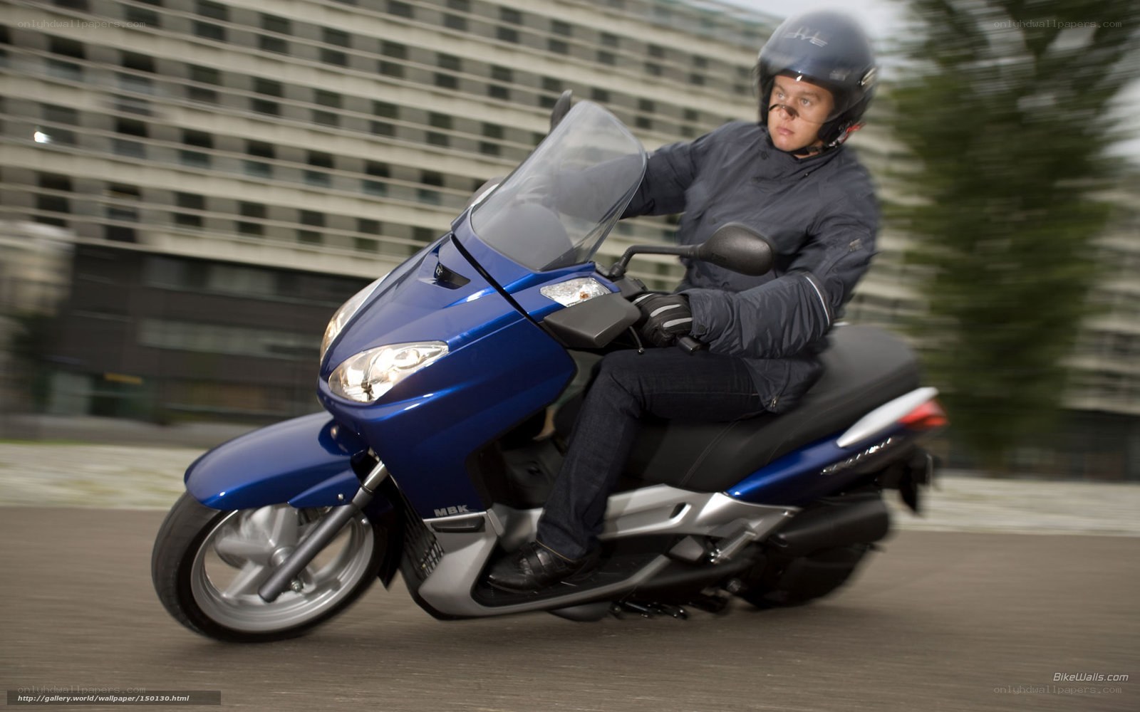 Man riding blue scooter