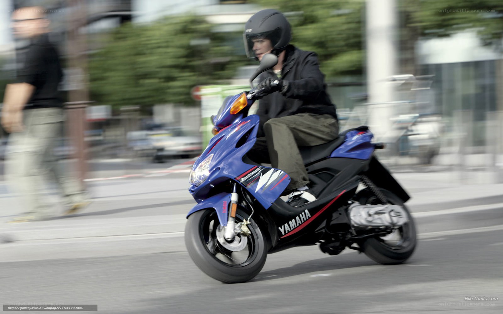 man riding blue scooter