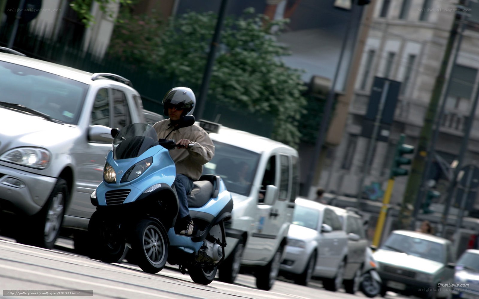 Man riding blue scooter in city