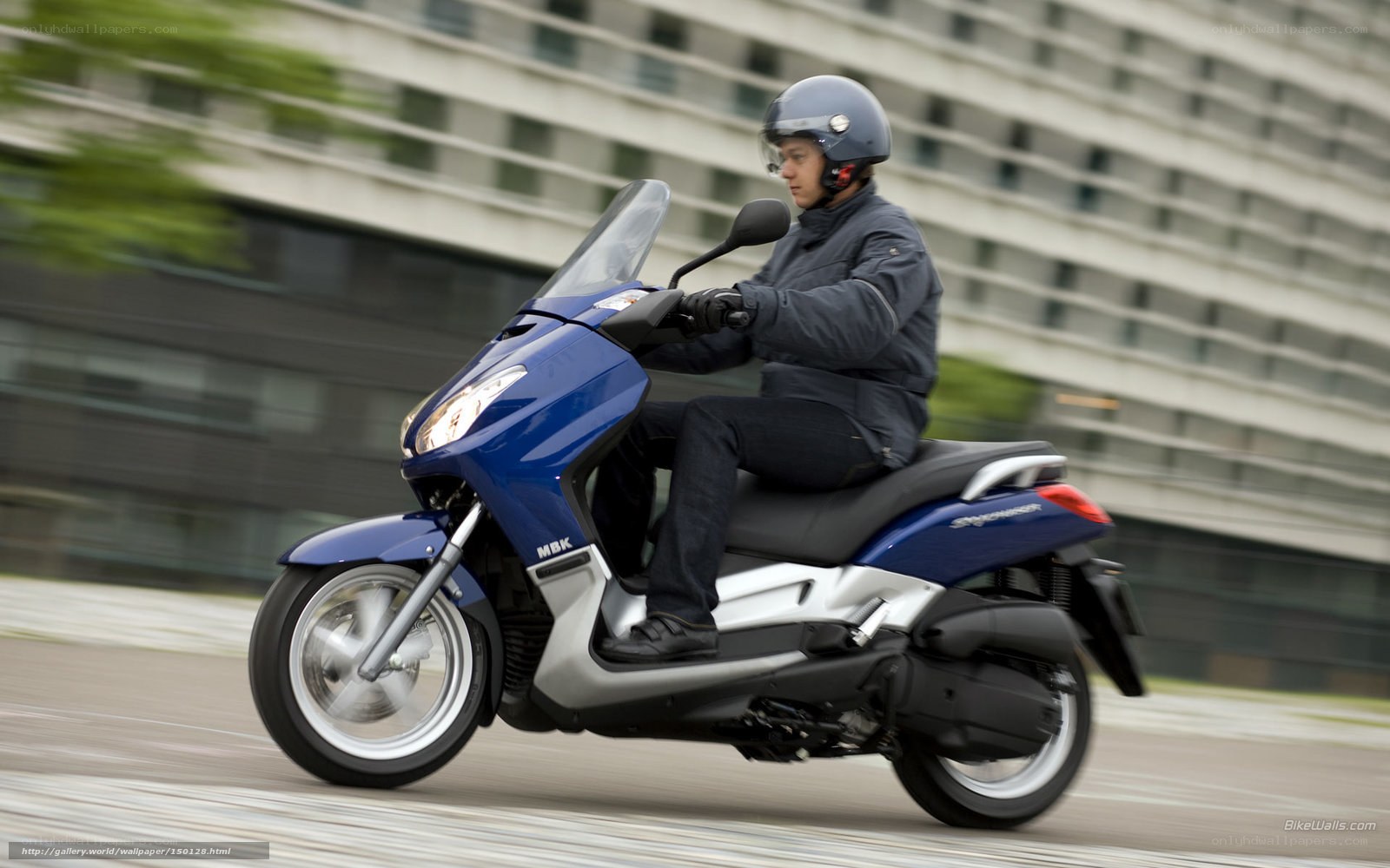 Man riding blue scooter