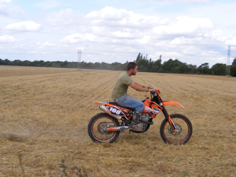Man riding dirt bike in field