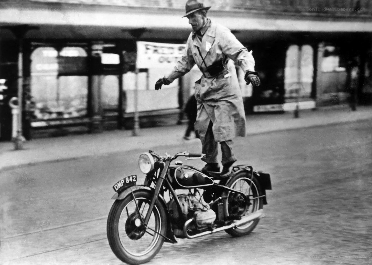 Man riding motorcycle in raincoat