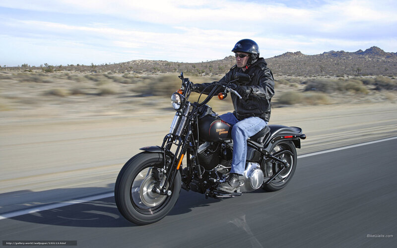 Man riding motorcycle on desert road