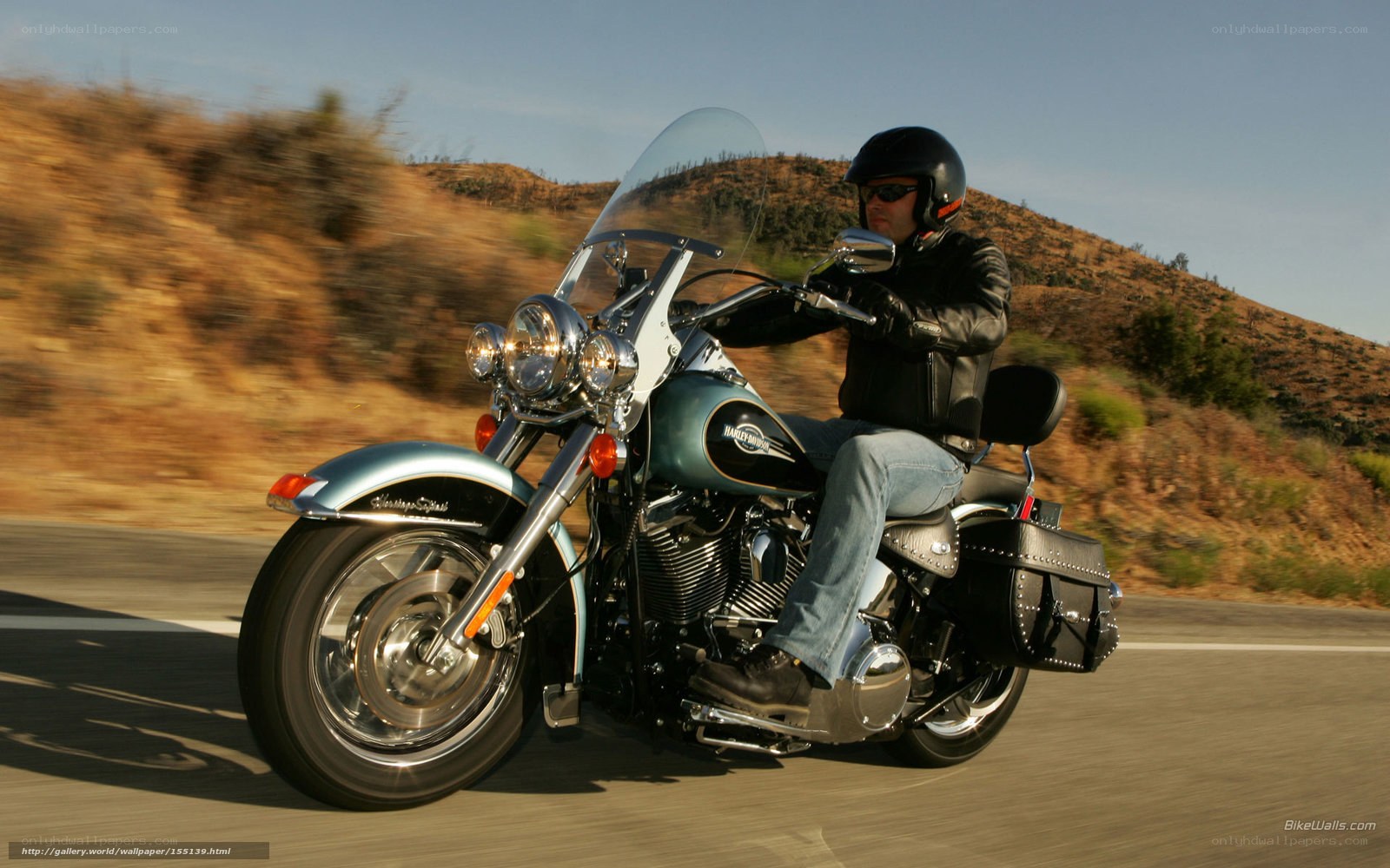 man riding motorcycle on road