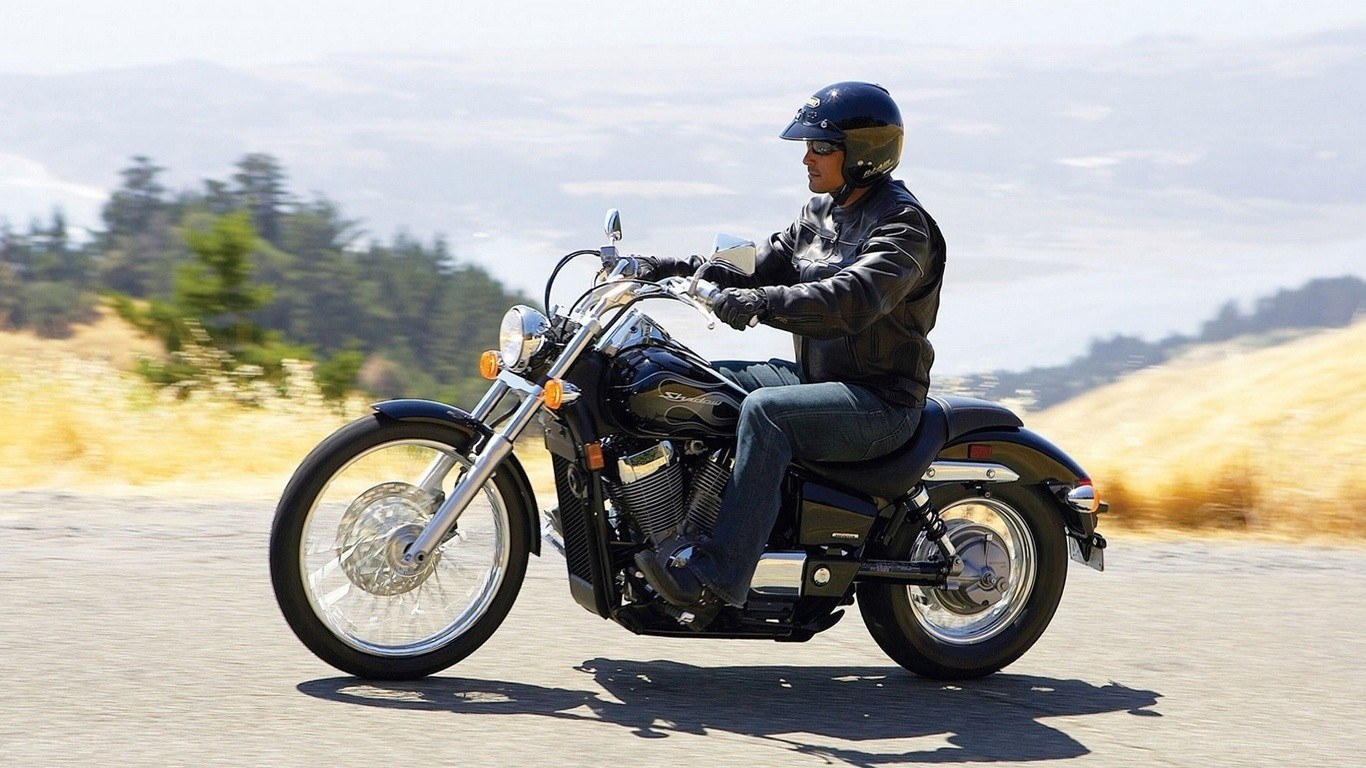 man riding motorcycle on road
