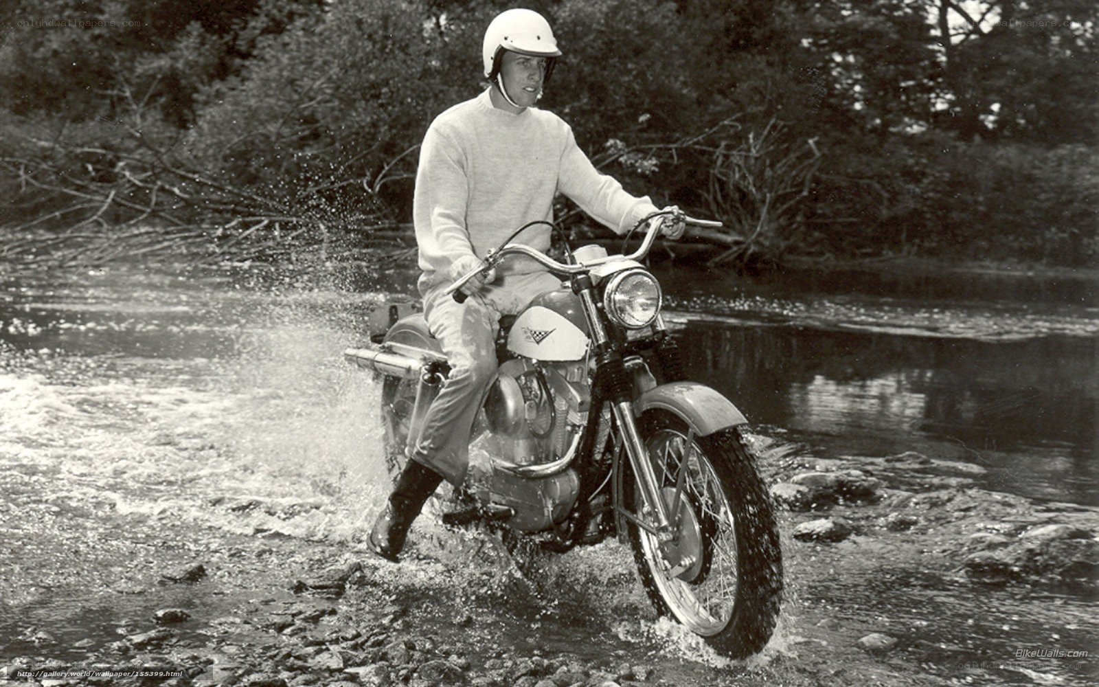 Man riding motorcycle through river