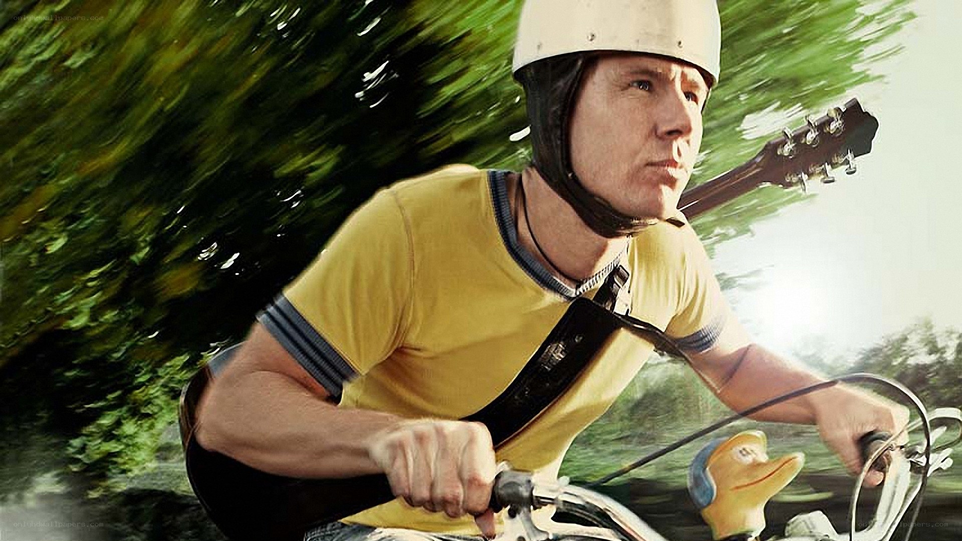 man riding motorcycle with guitar