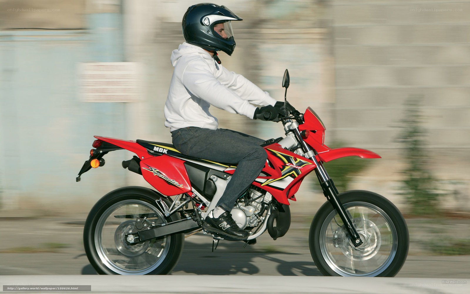 man riding red dirt bike