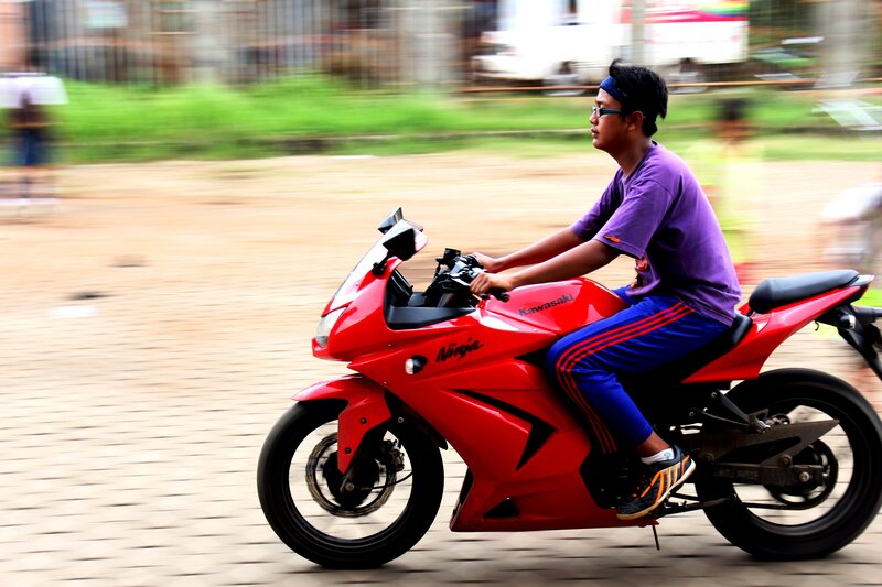Man riding red motorcycle