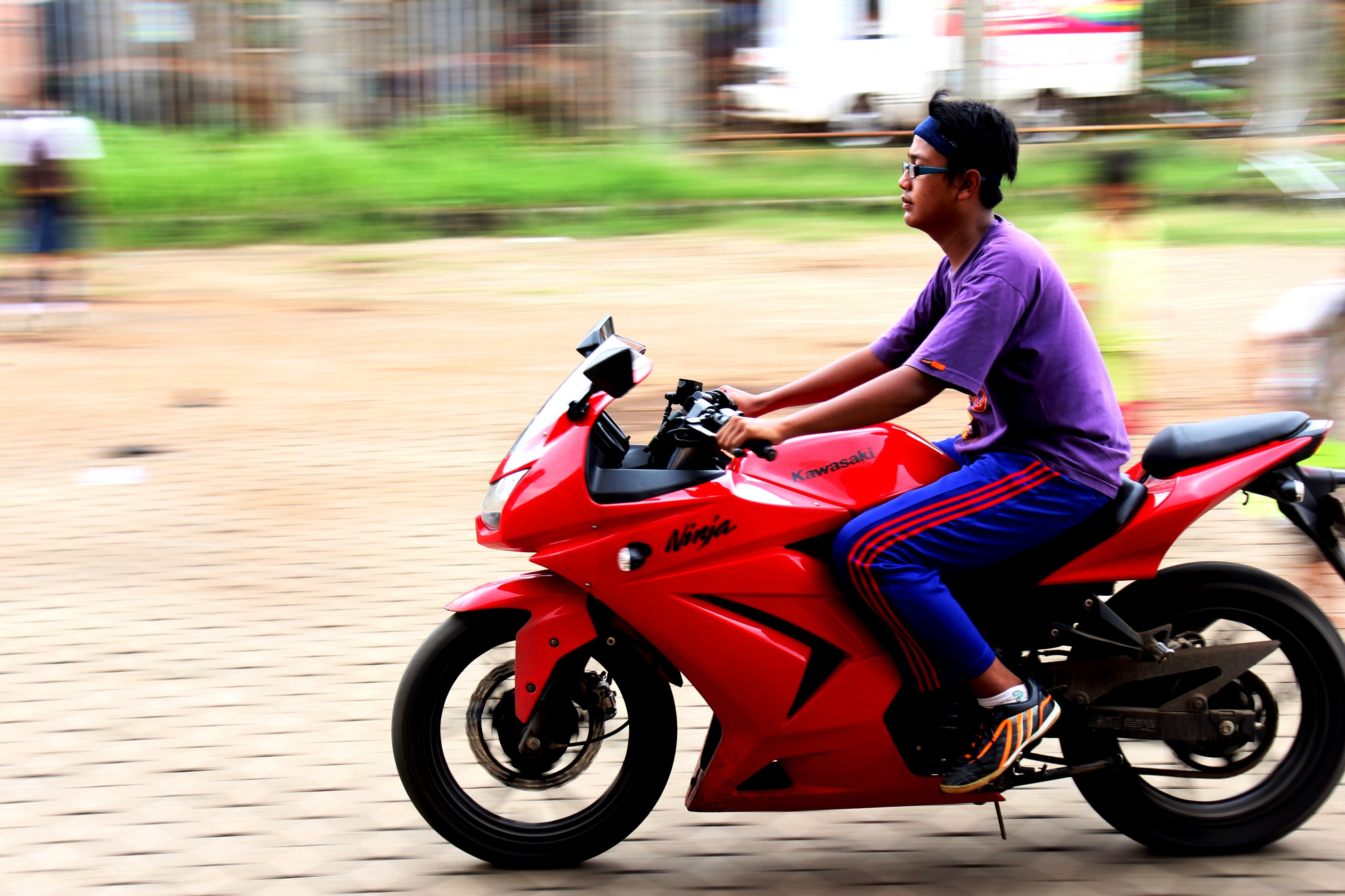 Man riding red motorcycle