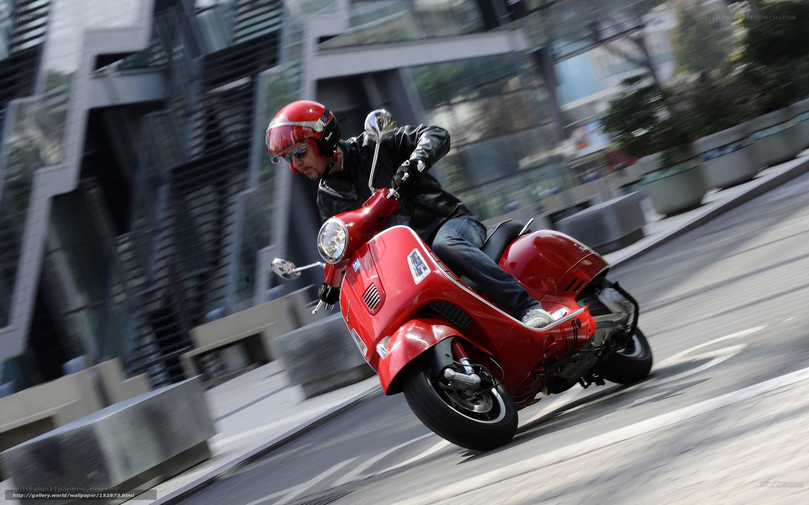 Man riding red scooter