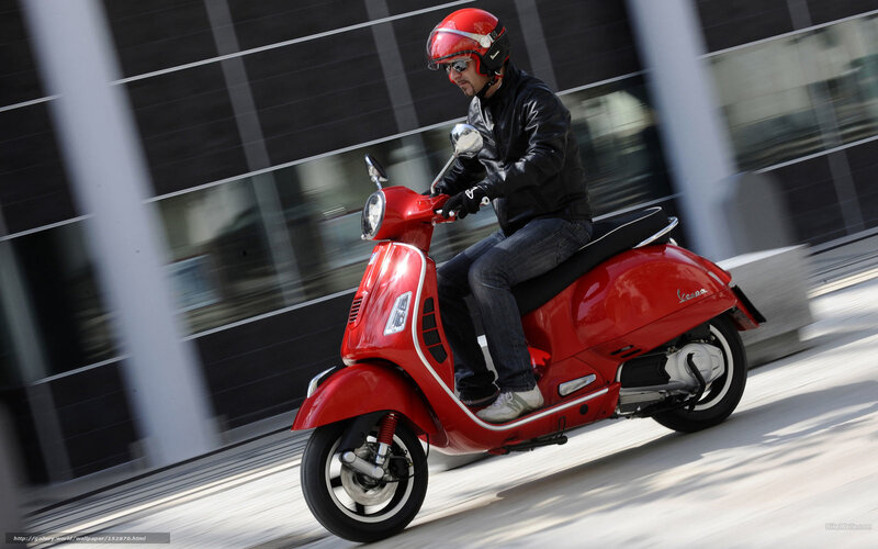 Man riding red scooter