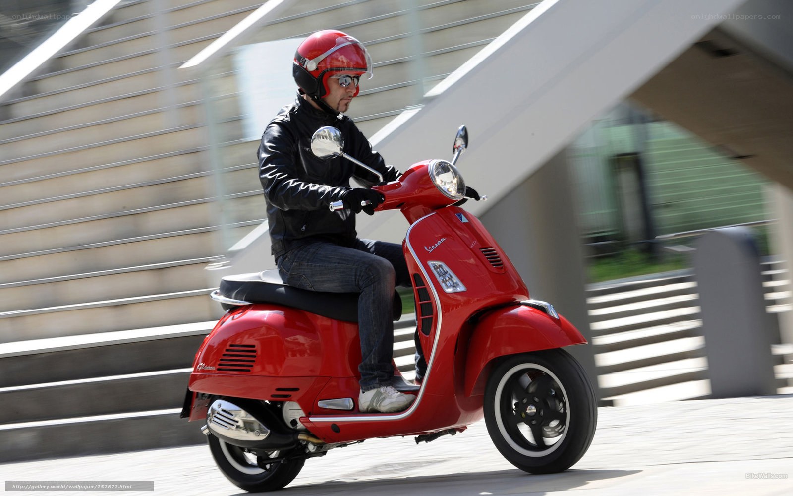 Man riding red scooter