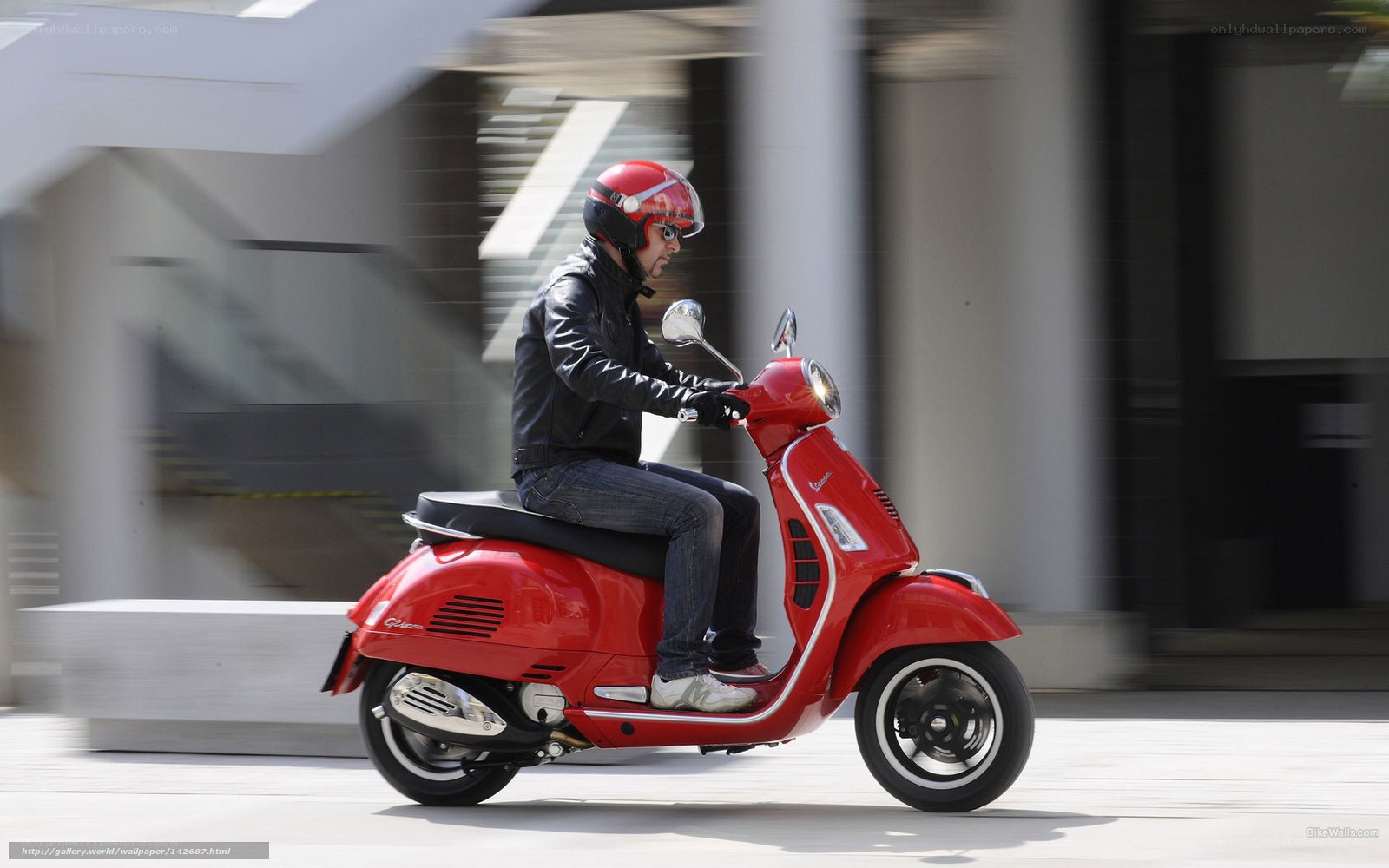 Man riding red scooter