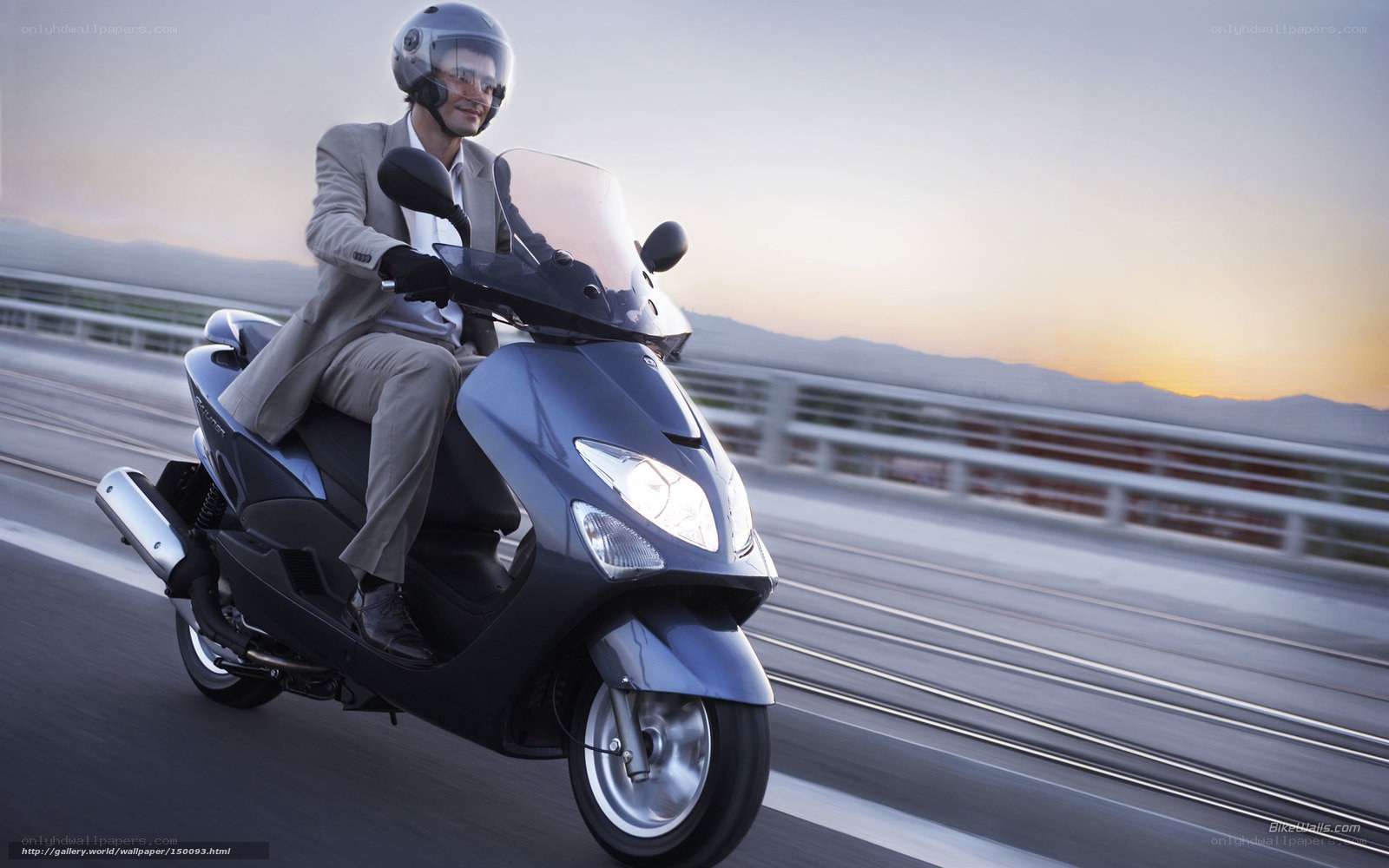 Man riding scooter at sunset