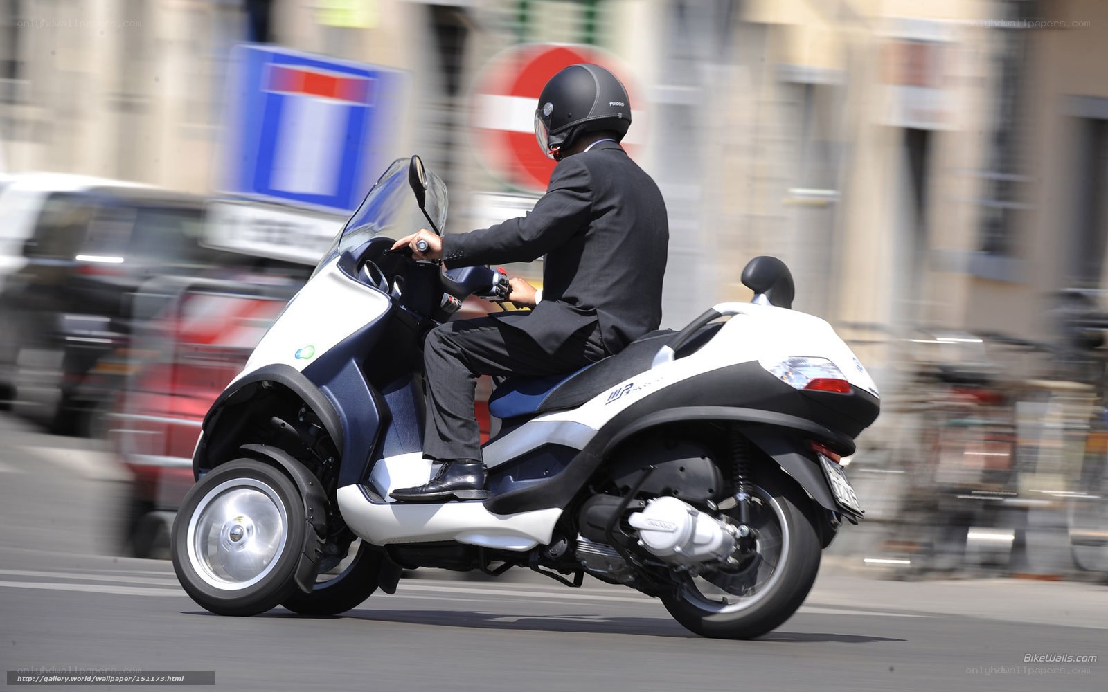 Man riding scooter in city