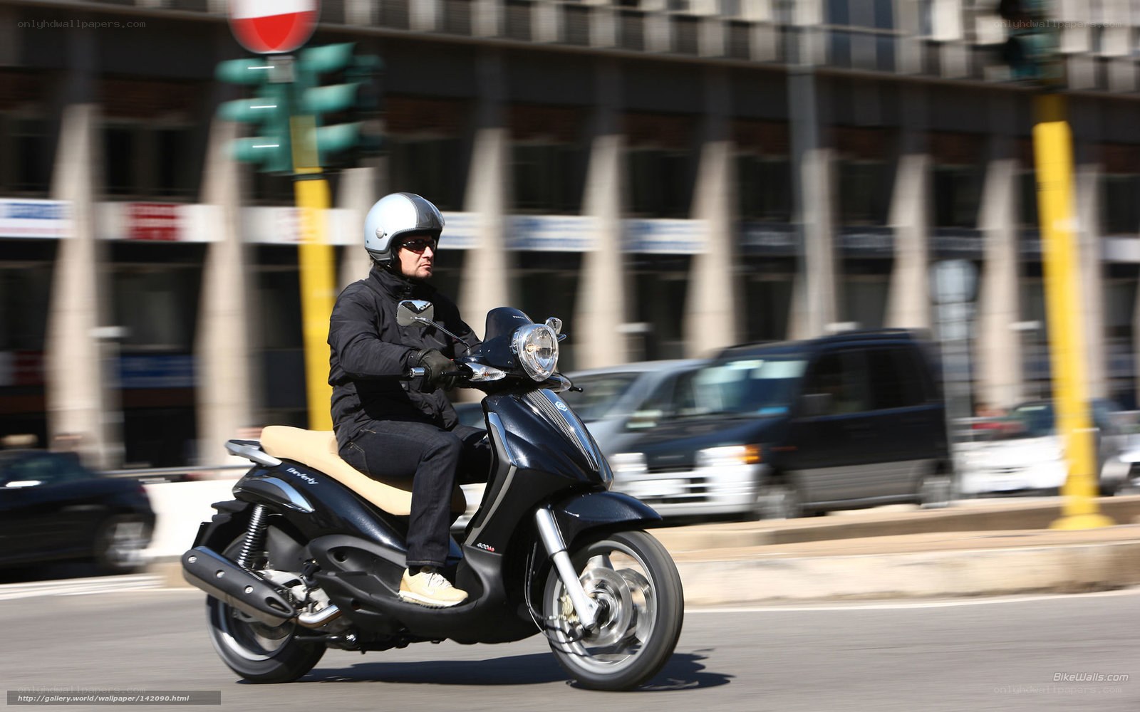 Man riding scooter in city