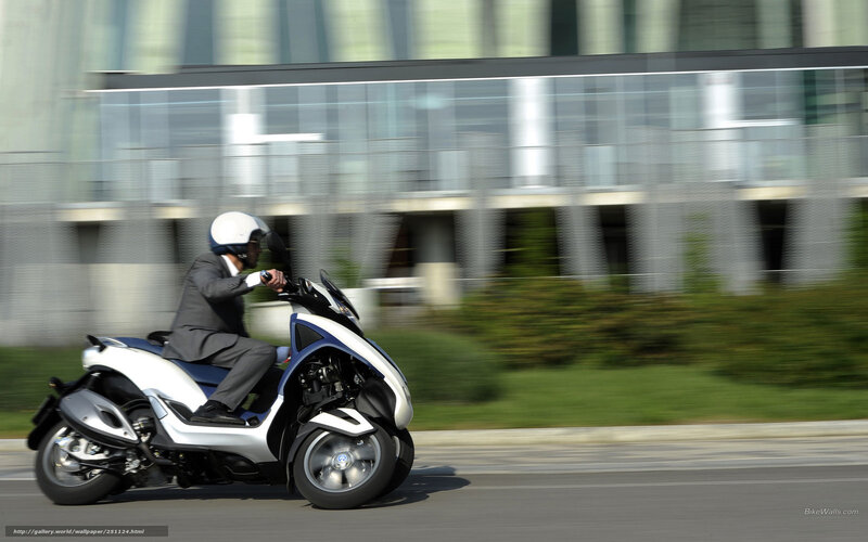 Man riding scooter in city