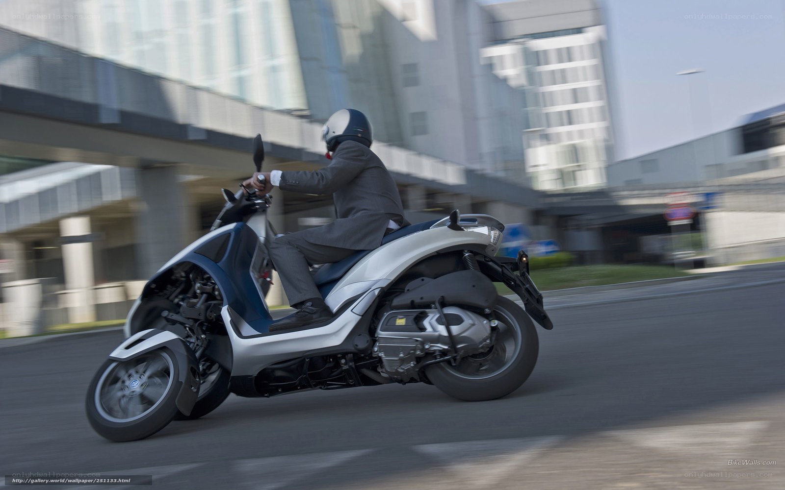 Man riding scooter in city