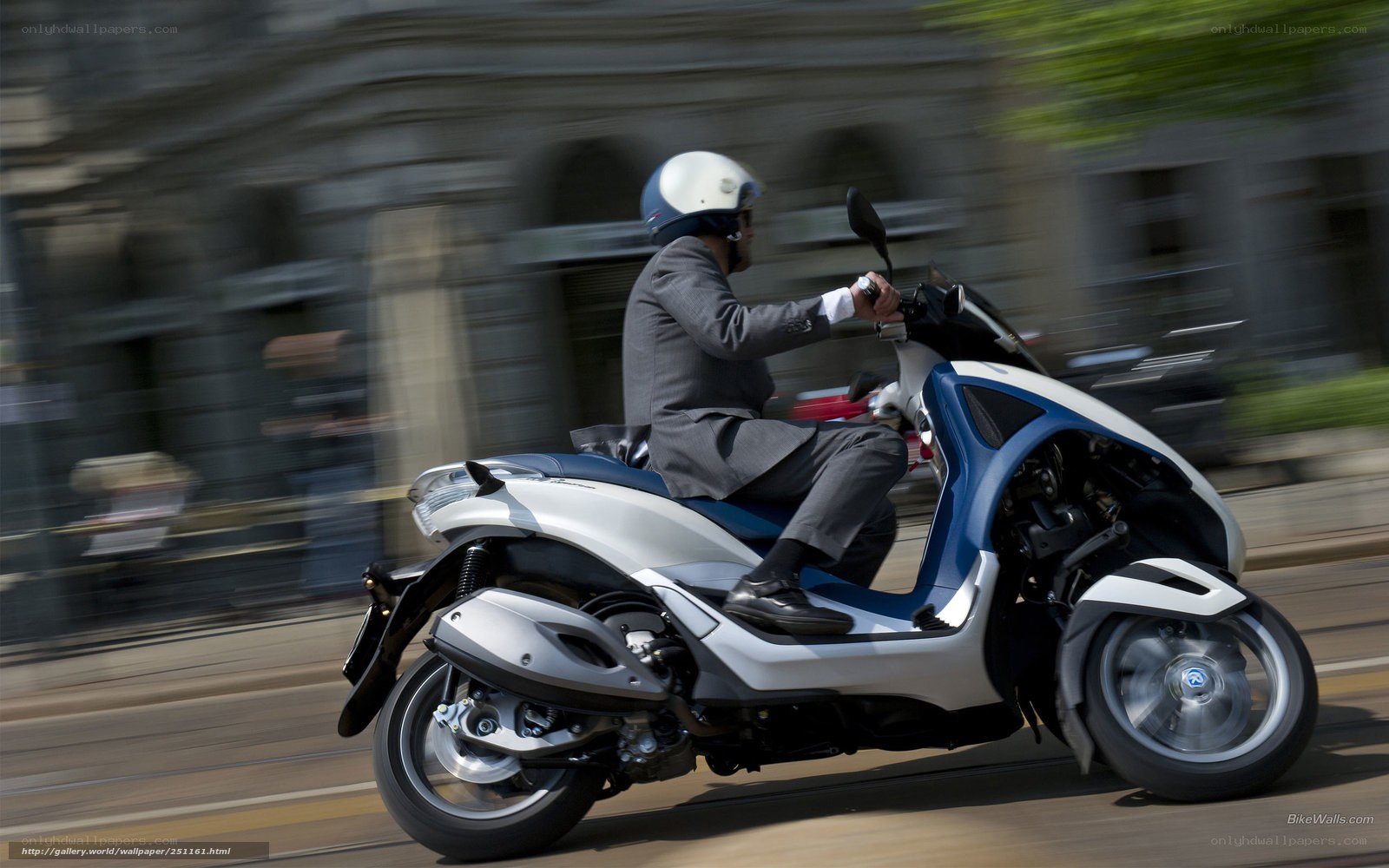 Man riding scooter in city