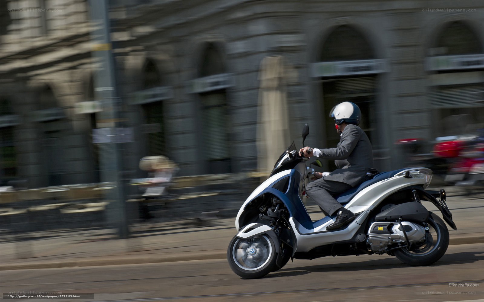 Man riding scooter in city