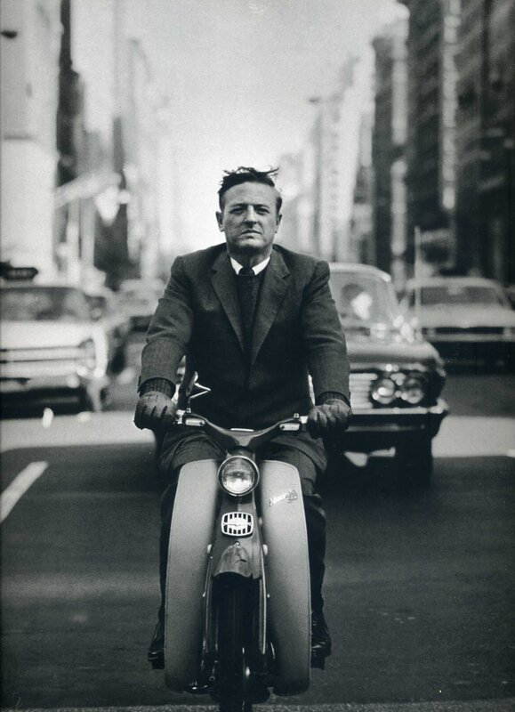 Man riding scooter in city