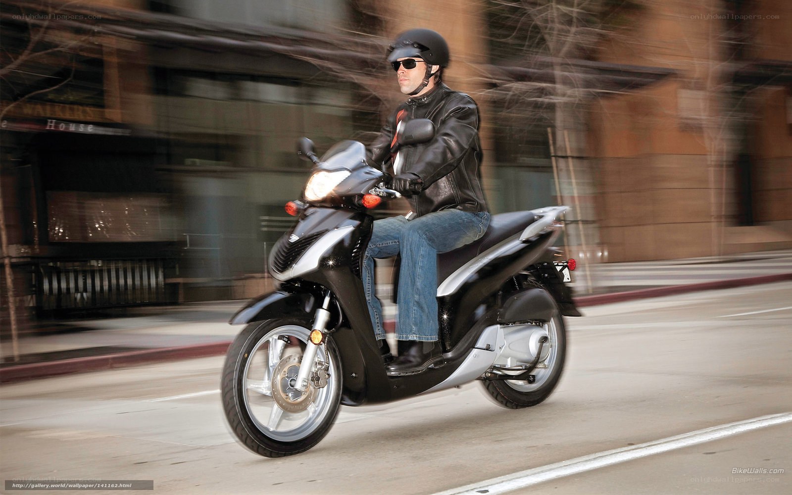 Man riding scooter in city