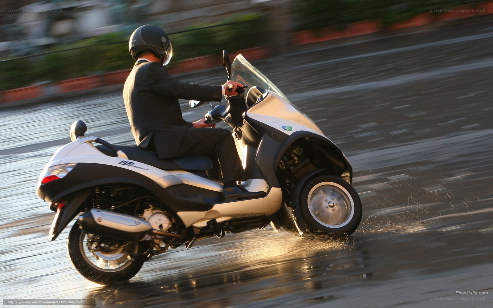Man riding scooter in rain