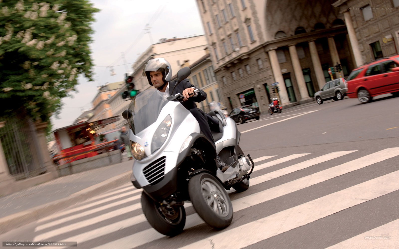 Man riding scooter on city street