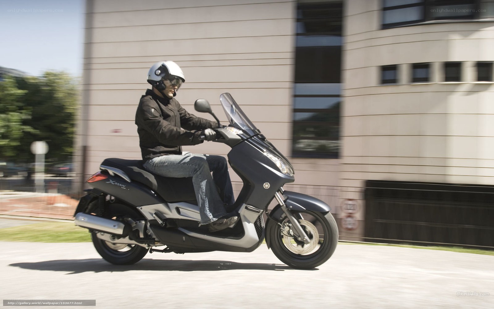 Man riding scooter on city street