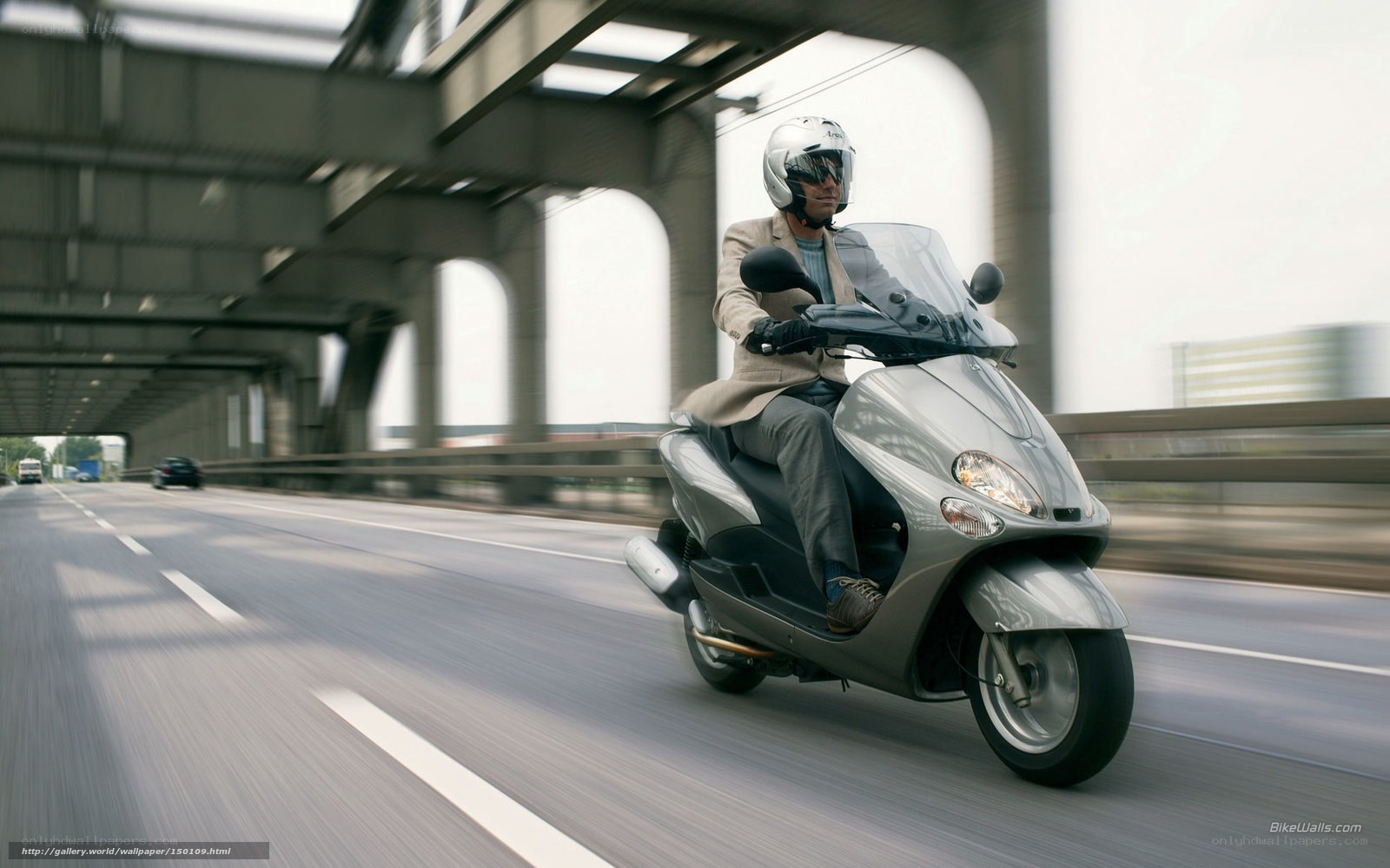 Man riding scooter on highway