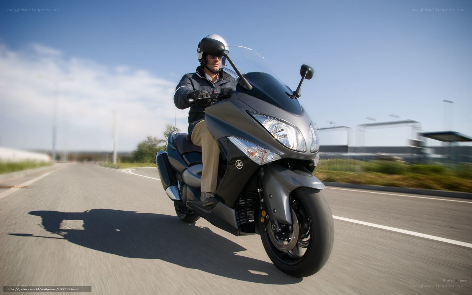 man riding scooter on road