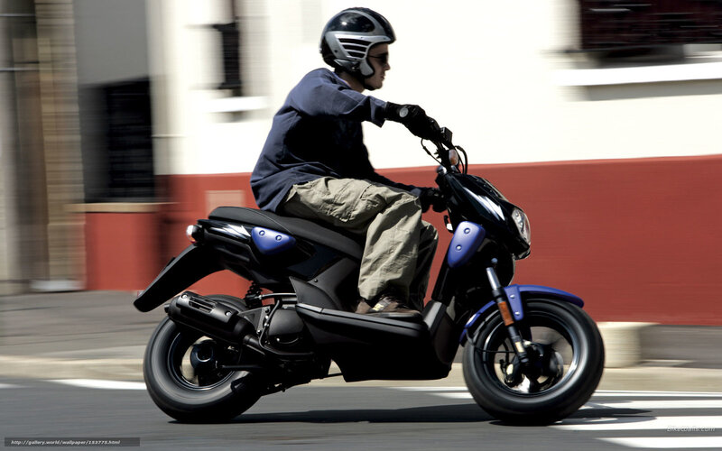 man riding scooter on street