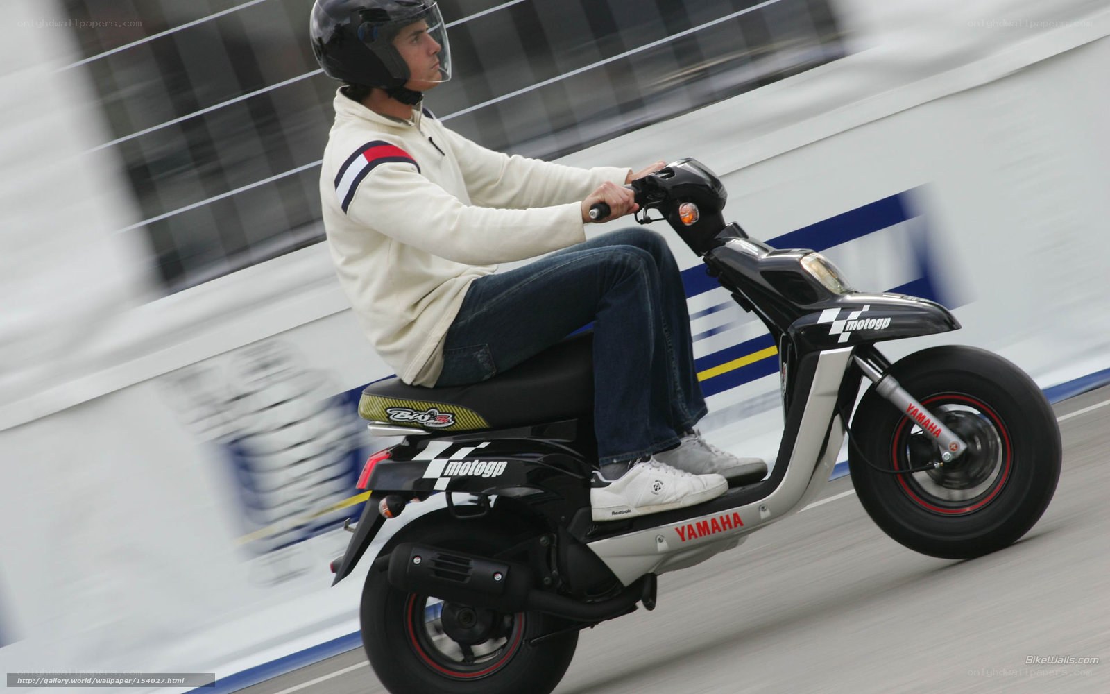 man riding scooter on track