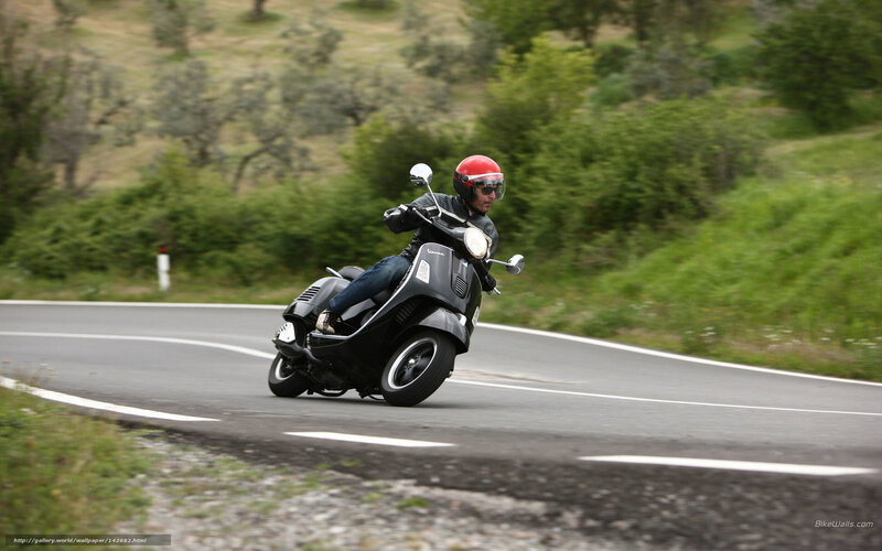 Man riding scooter on winding road